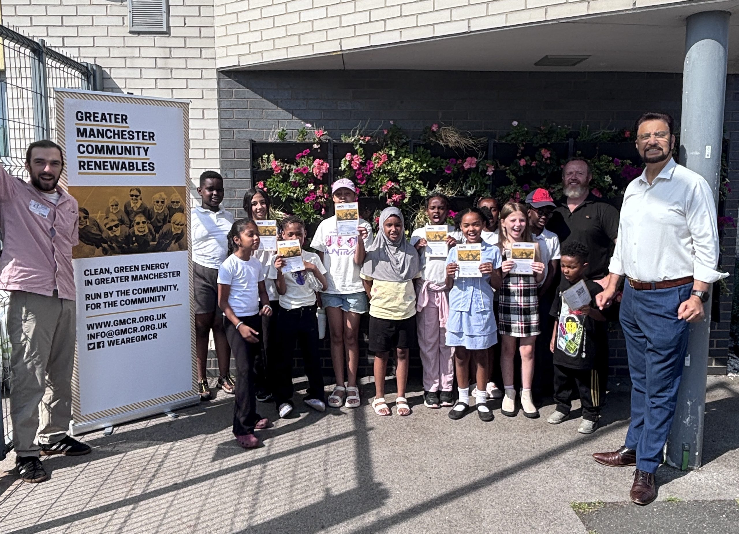 Photograph of schoolchildren, GMCR Director Tudor Baker, Afzal Khan MP and Luke at Divine Mercy Primary School